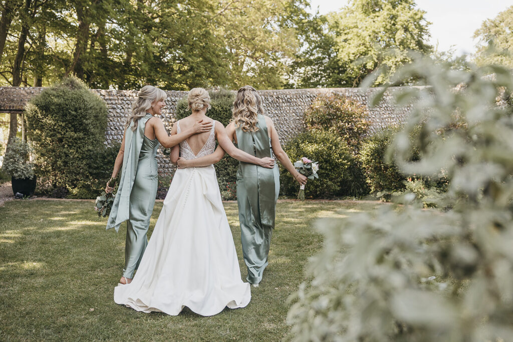 bride and bridesmaids in wildflower garden